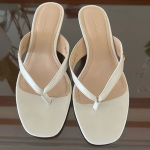 Coach off white sandals in a pretty good shaped.